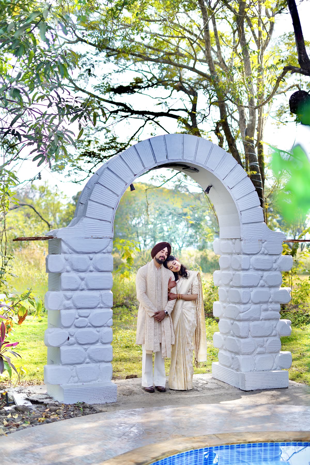 Under a whitewashed garden arch before the ceremony