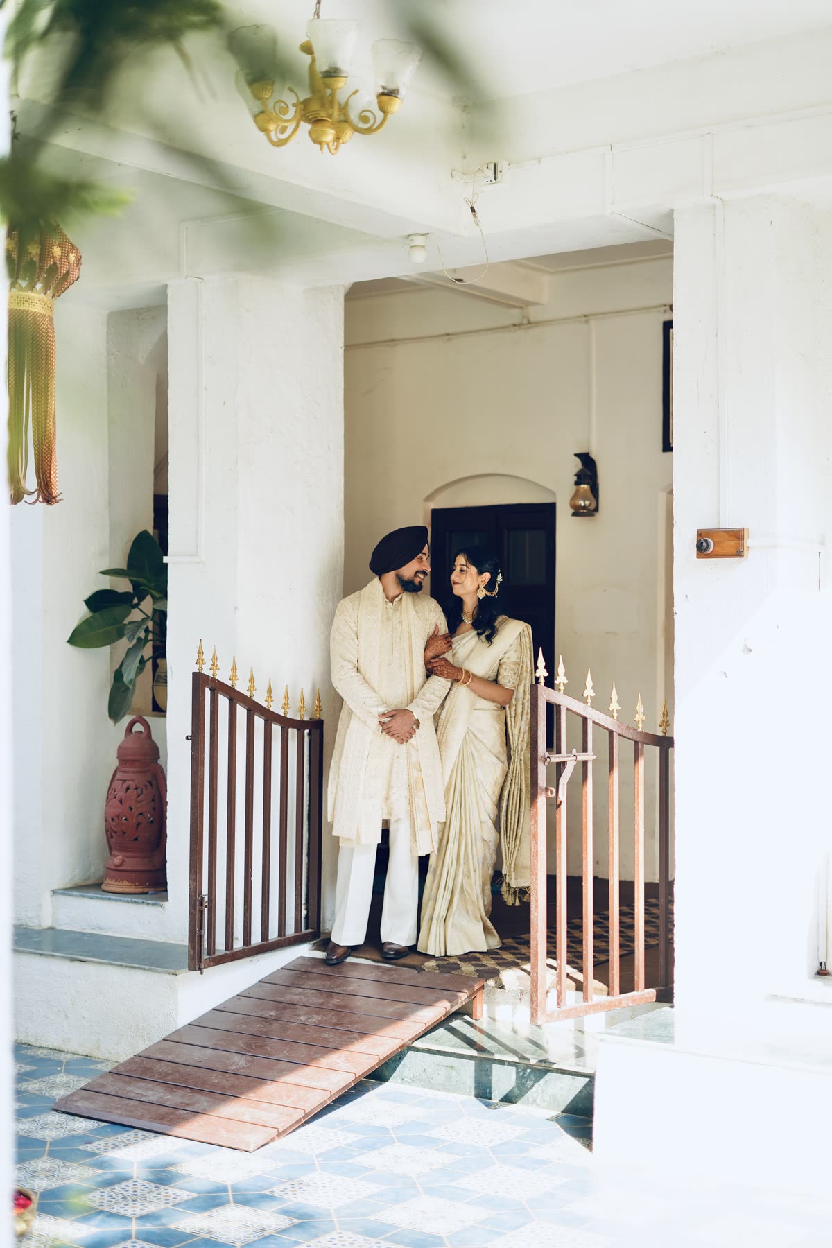 Framed in the doorway of a tiled colonial bungalow
