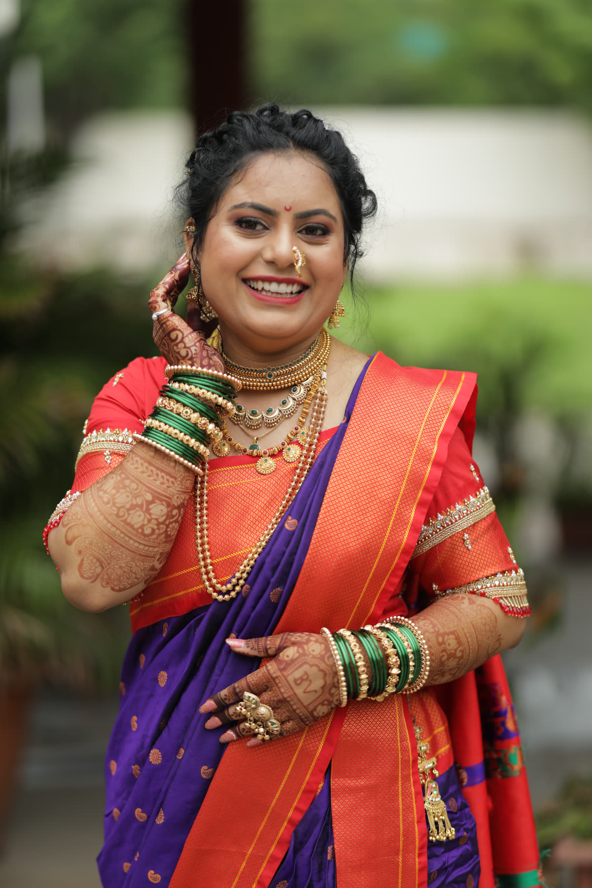 The bride laughing, hand to her earring