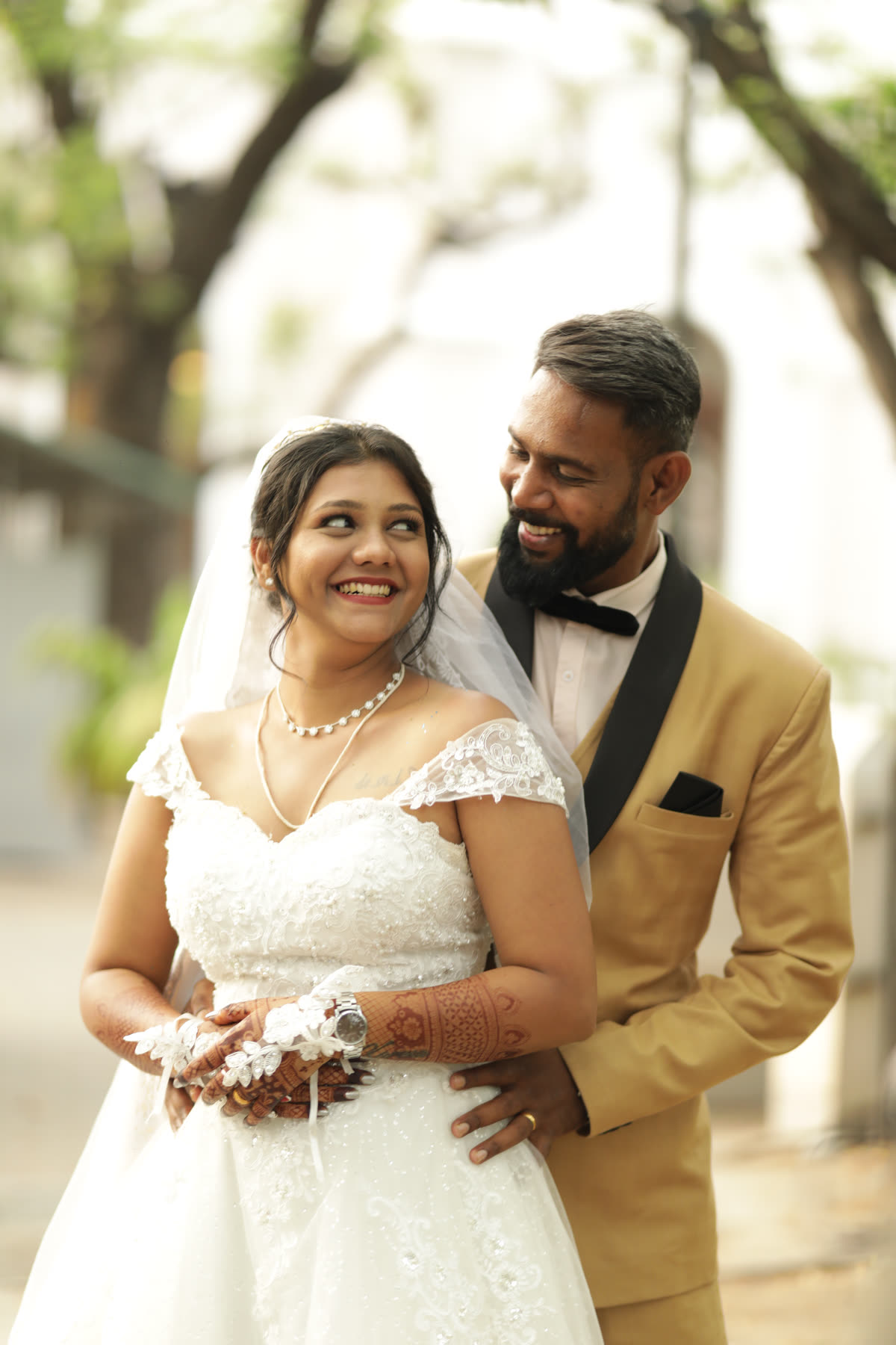 Veil, bouquet and a gold tuxedo after the vows