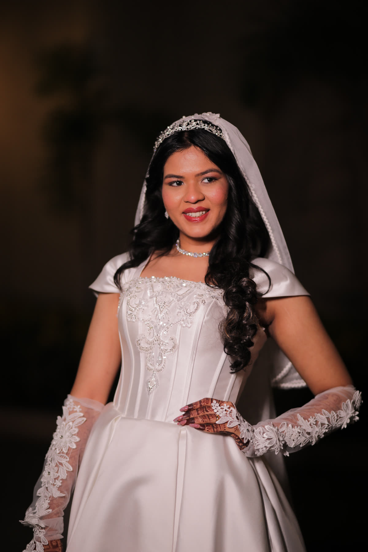 Bridal portrait in satin, lace gloves and a tiara