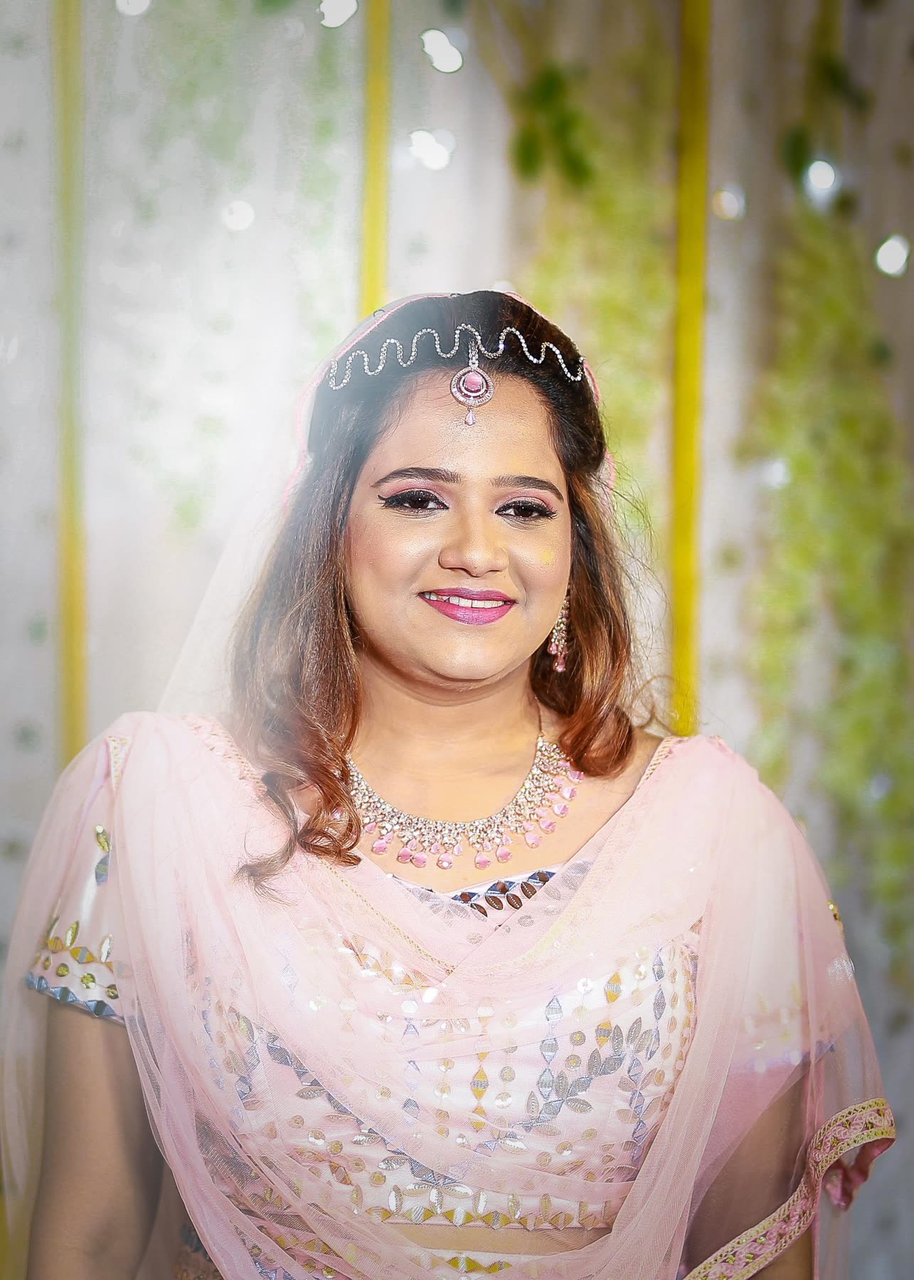 Bride in blush tulle beneath the maang tikka