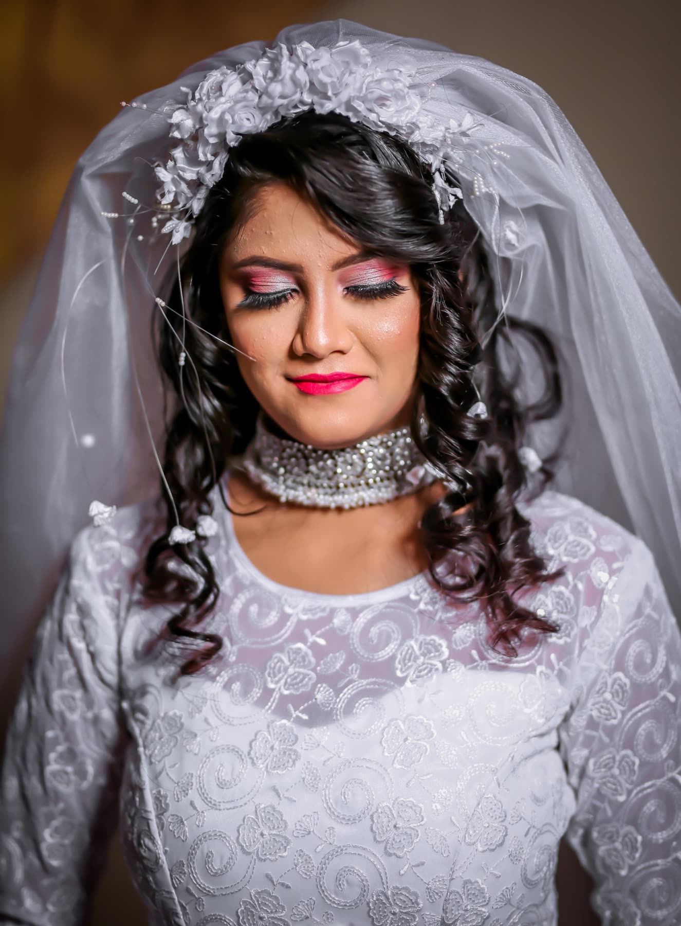 Eyes lowered under the lace veil before the vows